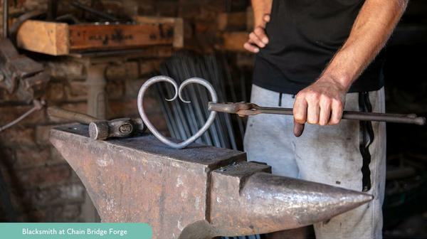 Blacksmith with a metal heart and clamp