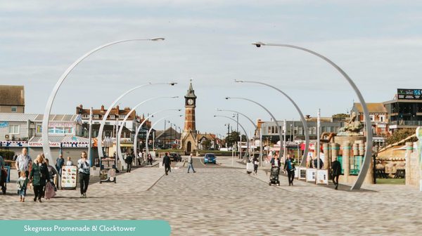 View of skegness clock tower from the sea front promenade under bright blue skies