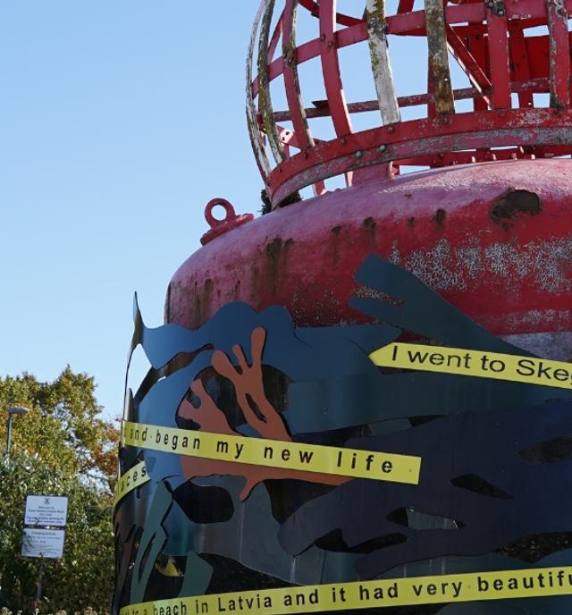 buoy art installation with sign in front